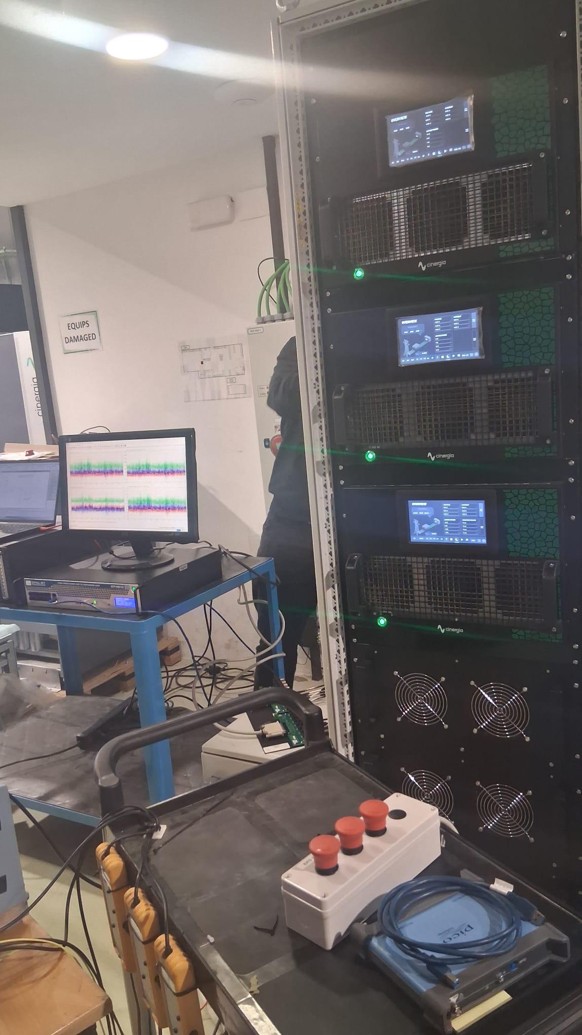 Real-time microgrid testing setup combining Cinergia hardware and laboratory instruments during the OPAL-RT training.